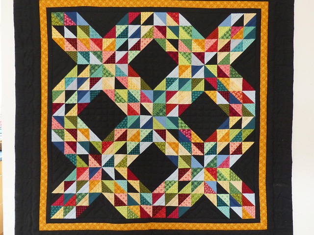 patchwork quilt pieces arranged in a grid with fabric textures and warm colors