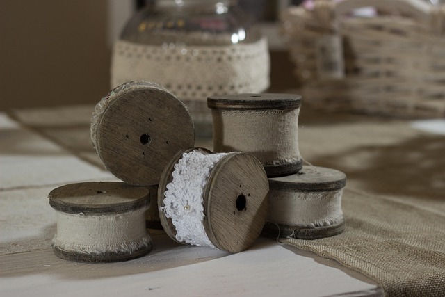 quilt fabric swatches, thread spools and sewing notions arranged neatly on a table